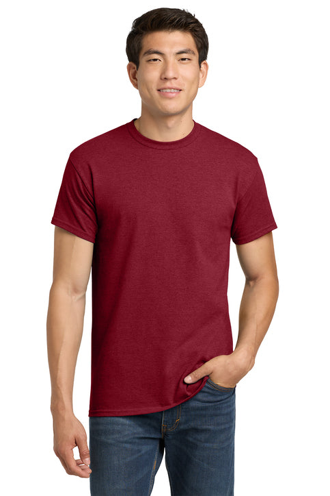 Man wearing a maroon t-shirt and blue jeans on a white background